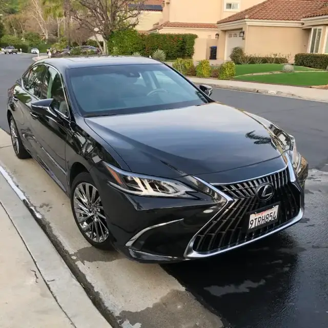 A black Lexus ES detailed at the curbside on a residential street in Calabasas, CA