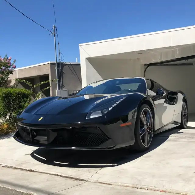 A black Ferrari detailed on a driveway in Woodland Hills, CA